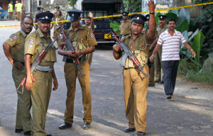 Sri Lankan police officers gather following a shootout on the outskirts of Colombo, Sri Lanka, Saturday, Oct. 8, 2011. A police official said former lawmaker Bharatha Lakshman Premachandra and two of his supporters were killed Saturday in an intraparty shootout during local council elections. (AP Photo/ Eranga Jayawardena)