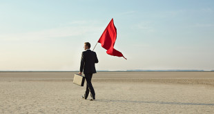 Businessman holding a red flag